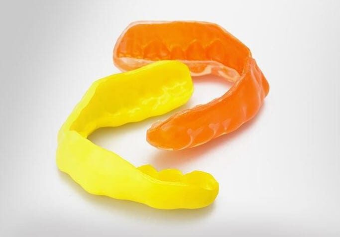 Yellow and Orange Samples of Mouthguards | athletic mouthguards in West Liberty, IA, North Liberty, IA and Muscatine, IA | Gentle Family Dentists
