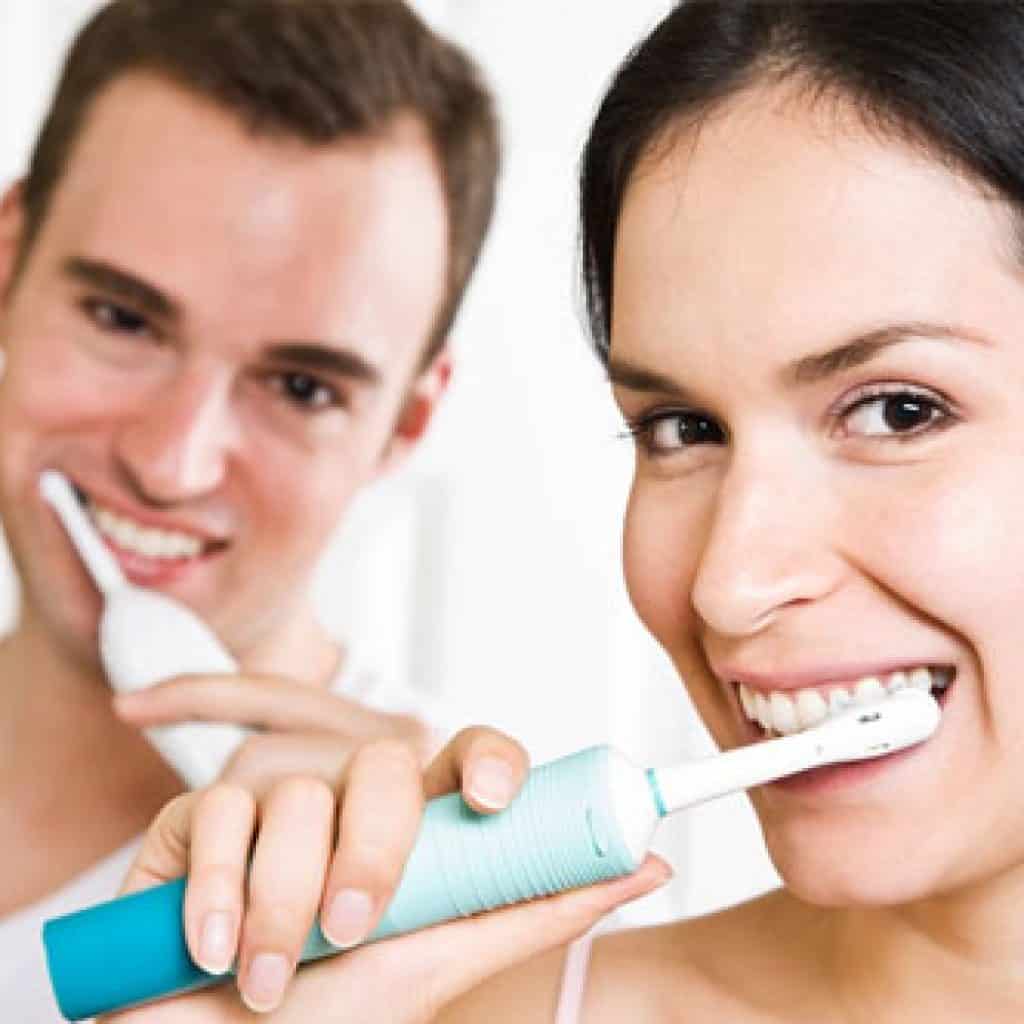 Man and Woman Brushing Their Teeth Together | Dental Prevention in West Liberty, IA, North Liberty, IA and Muscatine, IA | Gentle Family Dentists