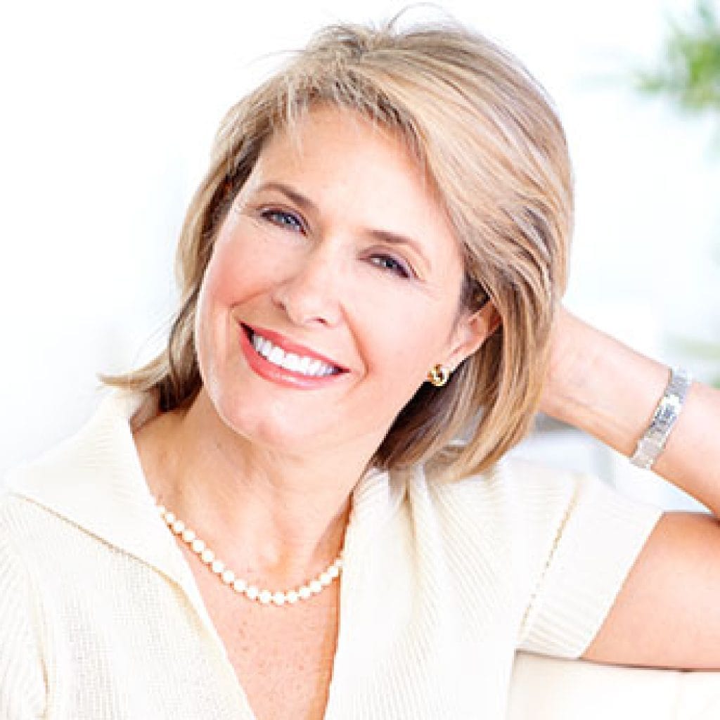 Smiling Old Woman looking elegantly | Dental Crowns and Bridges in West Liberty, IA, North Liberty, IA and Muscatine, IA | Gentle Family Dentists