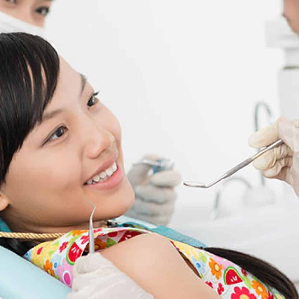 Smiling Young Girl with her Dentist | Dental Emergency in West Liberty, IA, North Liberty, IA and Muscatine, IA | Gentle Family Dentists