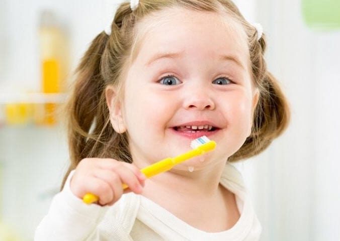 Cute Little Kid brushing her teeth | Pediatric Dentistry in West Liberty, IA | Gentle Family Dentists - Dr. Moreno