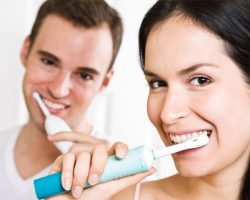 Man and Woman Brushing Their Teeth Together | Dental Prevention in West Liberty, IA, North Liberty, IA and Muscatine, IA | Gentle Family Dentists