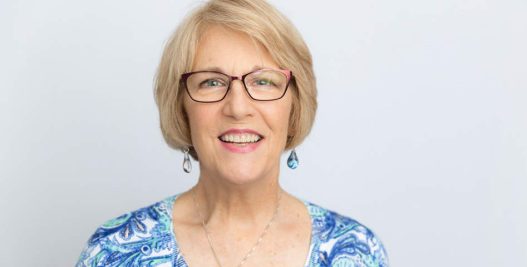 Mature Looking Woman with Eyeglasses Smiling | Dental Implants in West Liberty, IA | Gentle Family Dentists