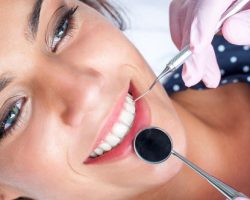 Young Lady Smiling While Having Her Dental Examination | Preventative Orthodontics Adults in West Liberty, IA, North Liberty, IA and Muscatine, IA | Gentle Family Dentists