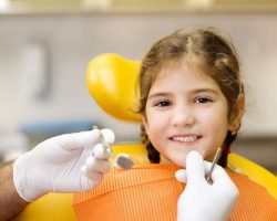 Smiling Little Girl During Her Dental Examination | Preventative Orthodontics Kids in West Liberty, IA, North Liberty, IA and Muscatine, IA | Gentle Family Dentists